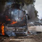 A bus burns on a road leading to the outskirts of Benghazi, eastern Libya